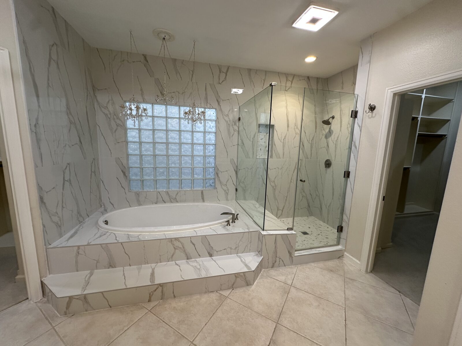 Bathroom remodel with marble-look tile and glass shower
